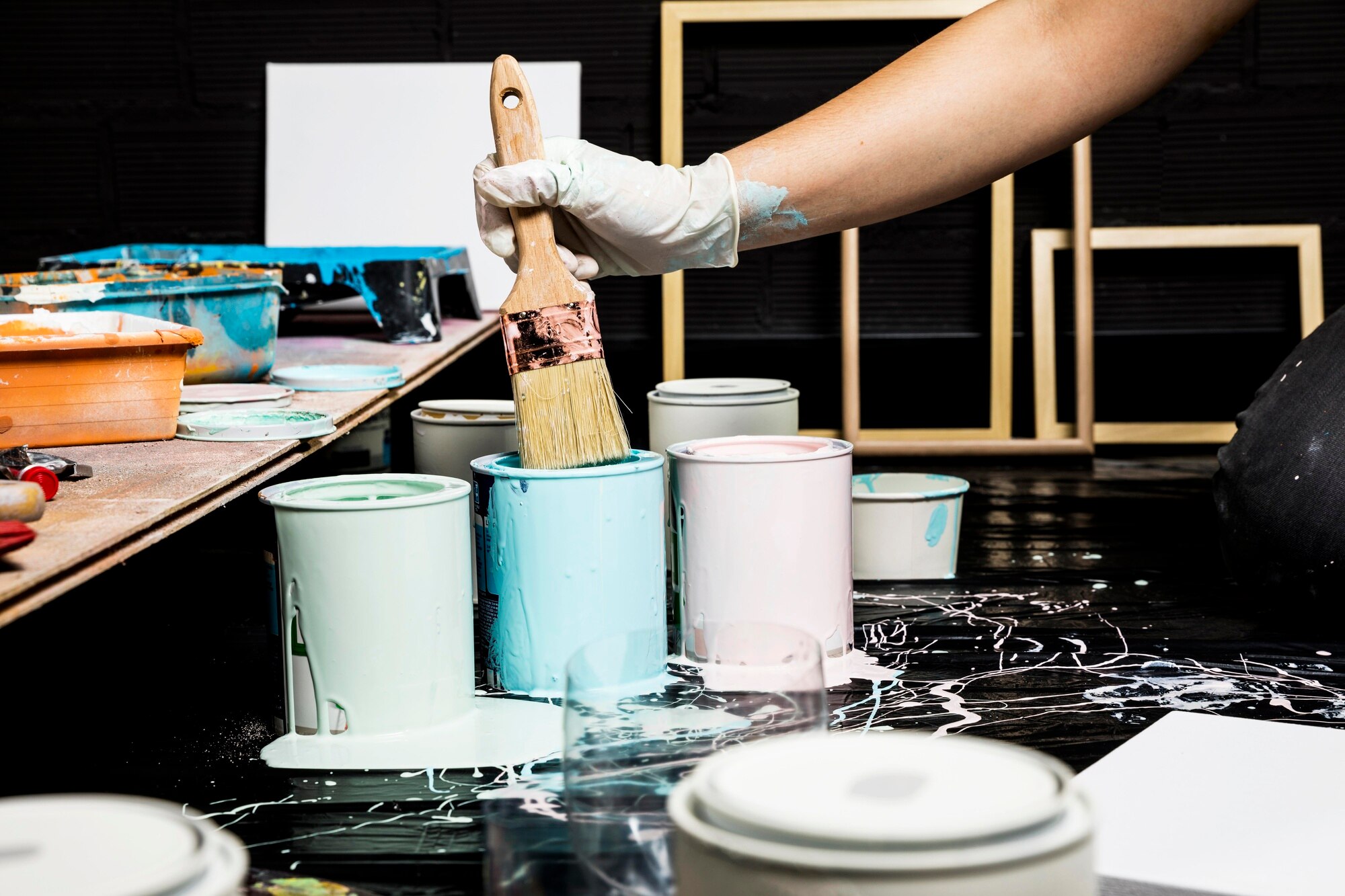 artists-using-paint-from-cans-with-brush_23-2148591278